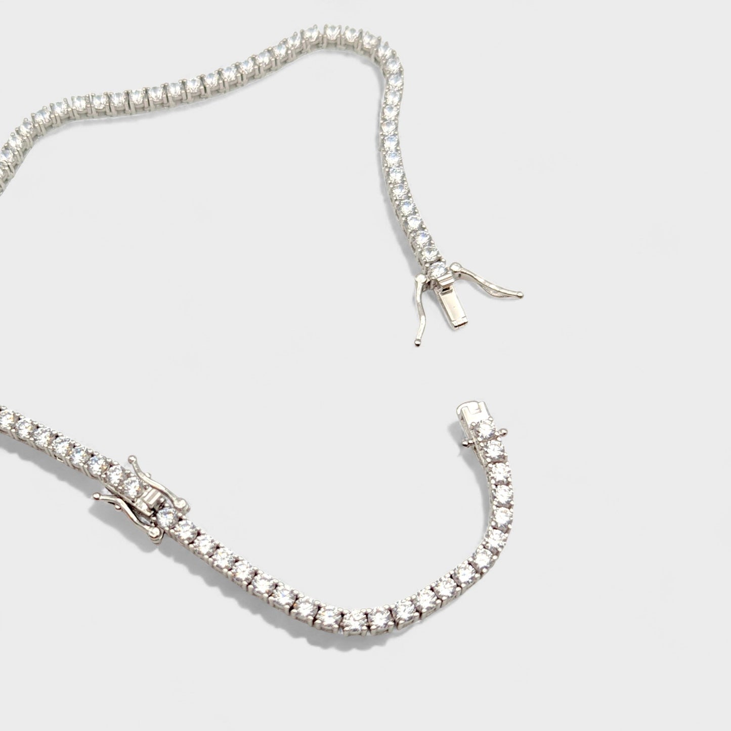 Close up of CHOE silver tennis necklace with extender