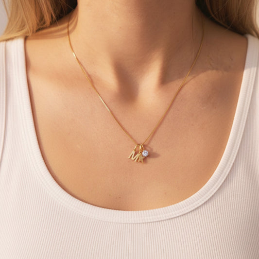 FYB personalized initial necklace in 18K gold plated sterling silver on a model's neck