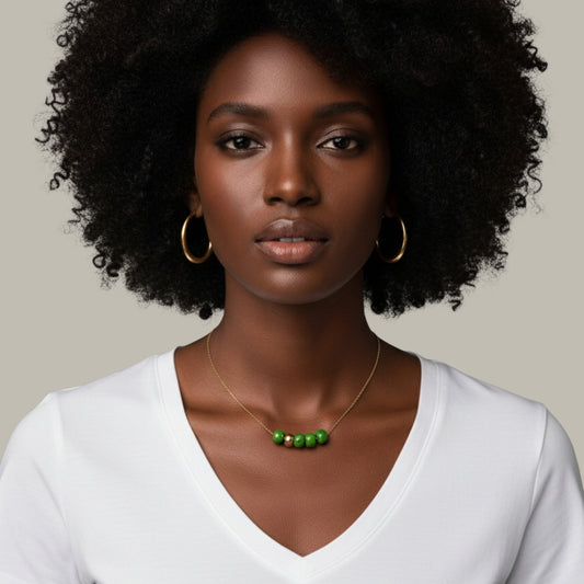 Maximilianas Cinco Cuentas with four green ceramic beads necklace and one gold bead - on model