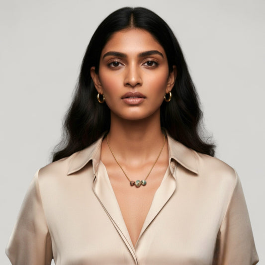 Woman wearing Maximilianas Tres Petras necklace with three forest green ceramic beads - hero shot.