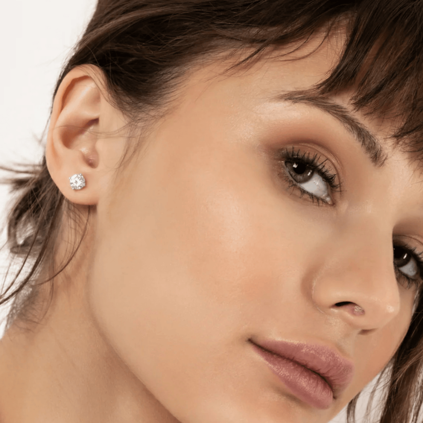 CHOE classic moissanite studs in rhodium-plated sterling silver on female model - head shot