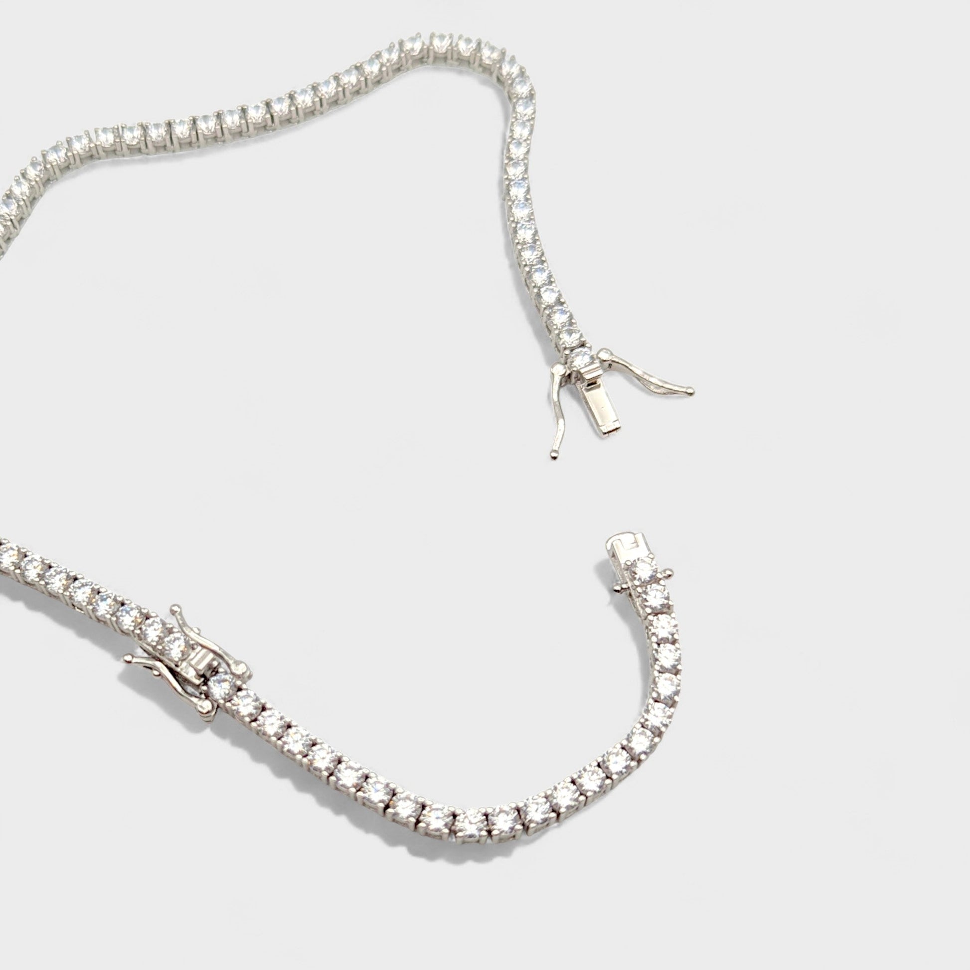 Close up of CHOE silver tennis necklace with extender