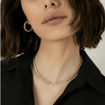CHOE classic tennis necklace in gold vermeil - close up of a woman wearing the tennis necklace