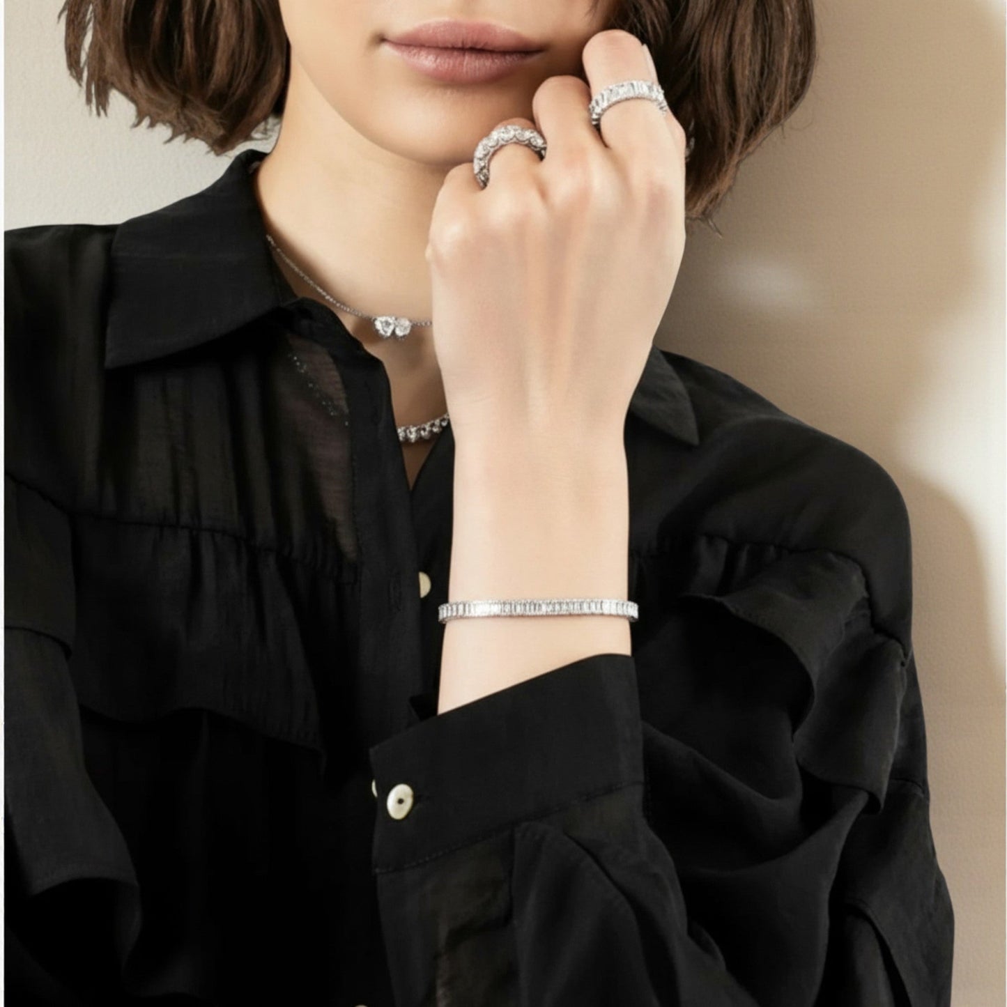 CHOE emerald bezel bracelet on a woman's writst - hero shot showing rectangular stone settings