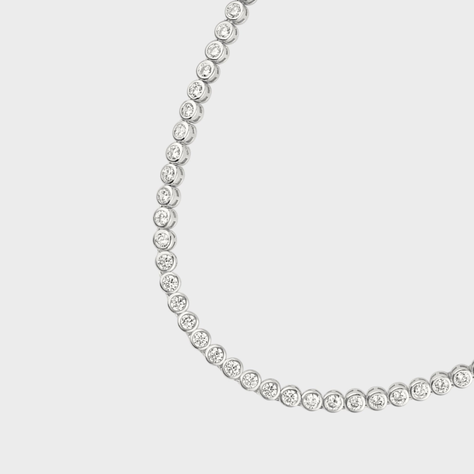 Close up of CHOE cubic zirconia tennis necklace on a light gray background