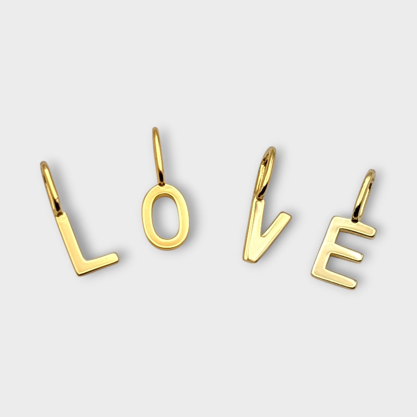 FYB initial charms spelling 'LOVE' on a light gray background