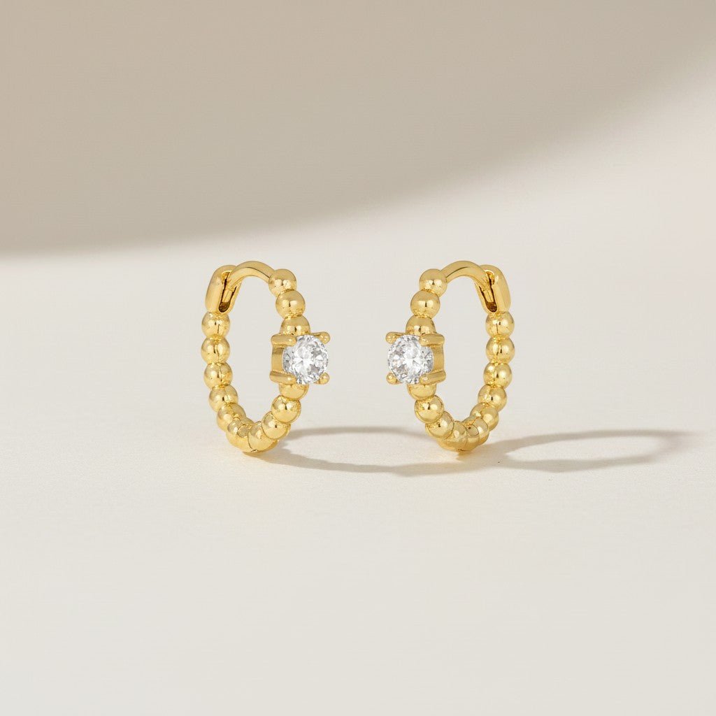 IRLÔH gold plated sterling silver huggie hoop earrings with cubic zirconia stones, 10mm diameter.