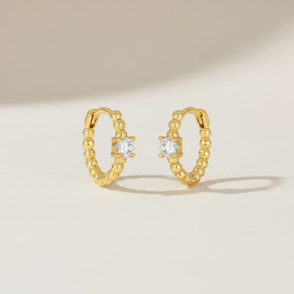 IRLÔH gold plated sterling silver huggie hoop earrings with cubic zirconia stones, 10mm diameter.