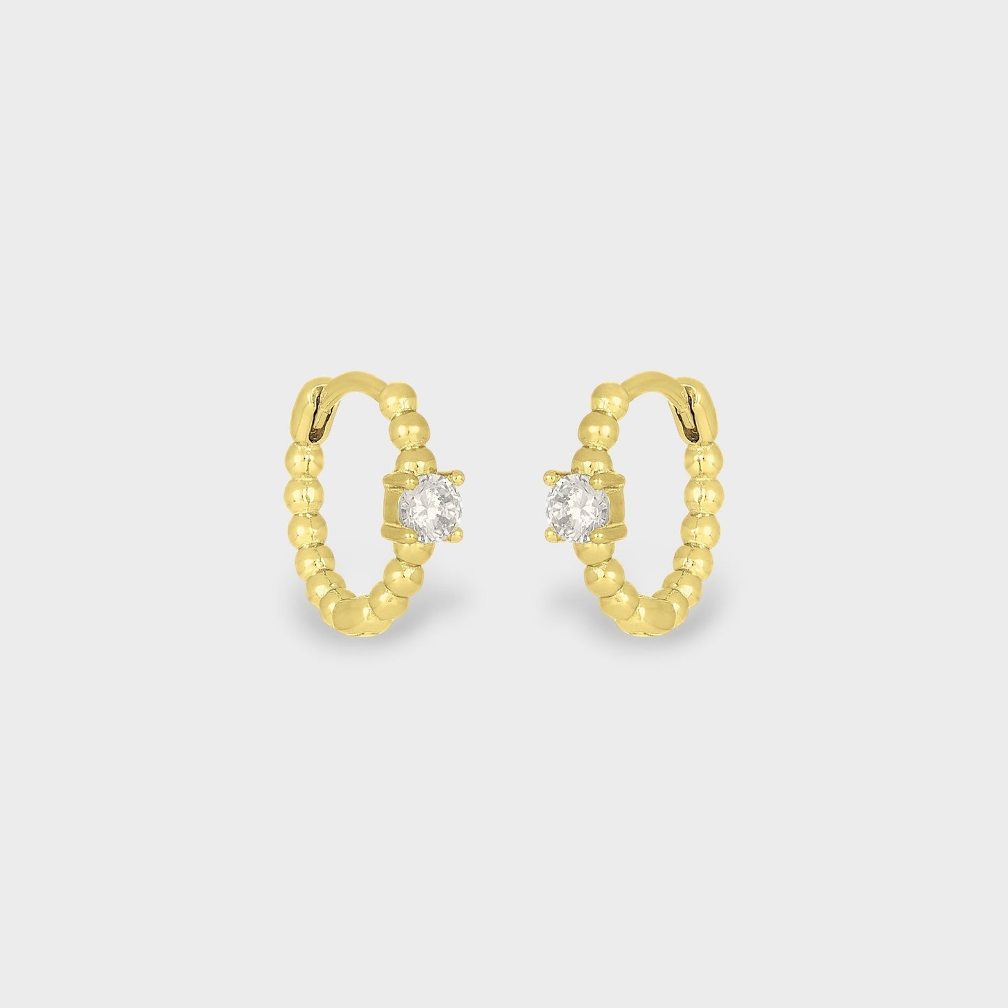 FYB Zia gold huggie earrings with single cubic zirconia stone