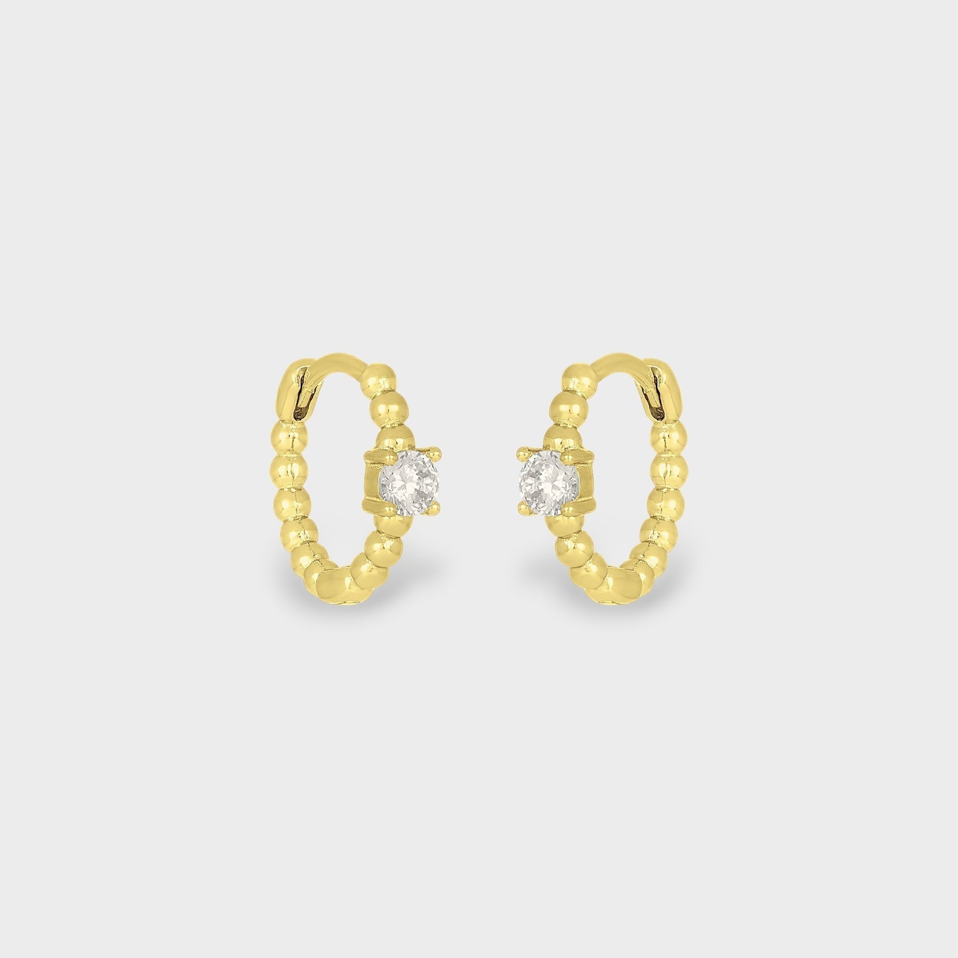 FYB Zia gold huggie earrings with single cubic zirconia stone