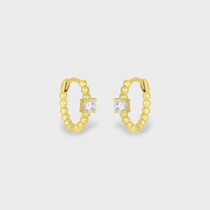 FYB Zia gold huggie earrings with single cubic zirconia stone