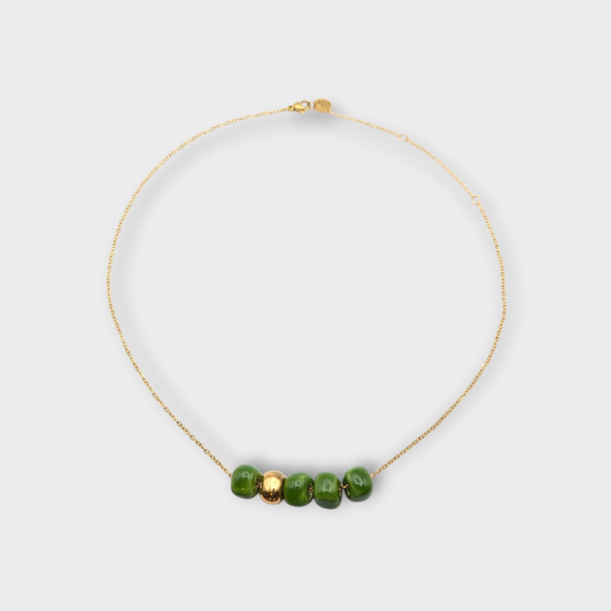Maximilianas Cinco Cuentas necklace with four green ceramic beads and one gold ceramic bead