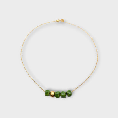 Maximilianas Cinco Cuentas necklace with four green ceramic beads and one gold ceramic bead