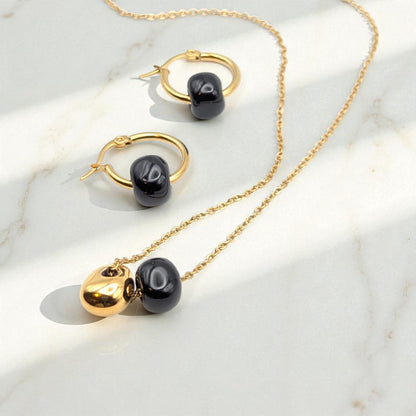 Maximilianas Cuenta hoop earrings with removable ceramic bead and matching necklace - hero shot