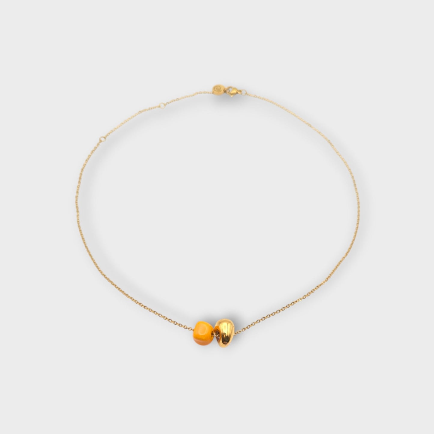 Maximilianas Dos Cuentas necklace with one orange and one gold ceramic bead