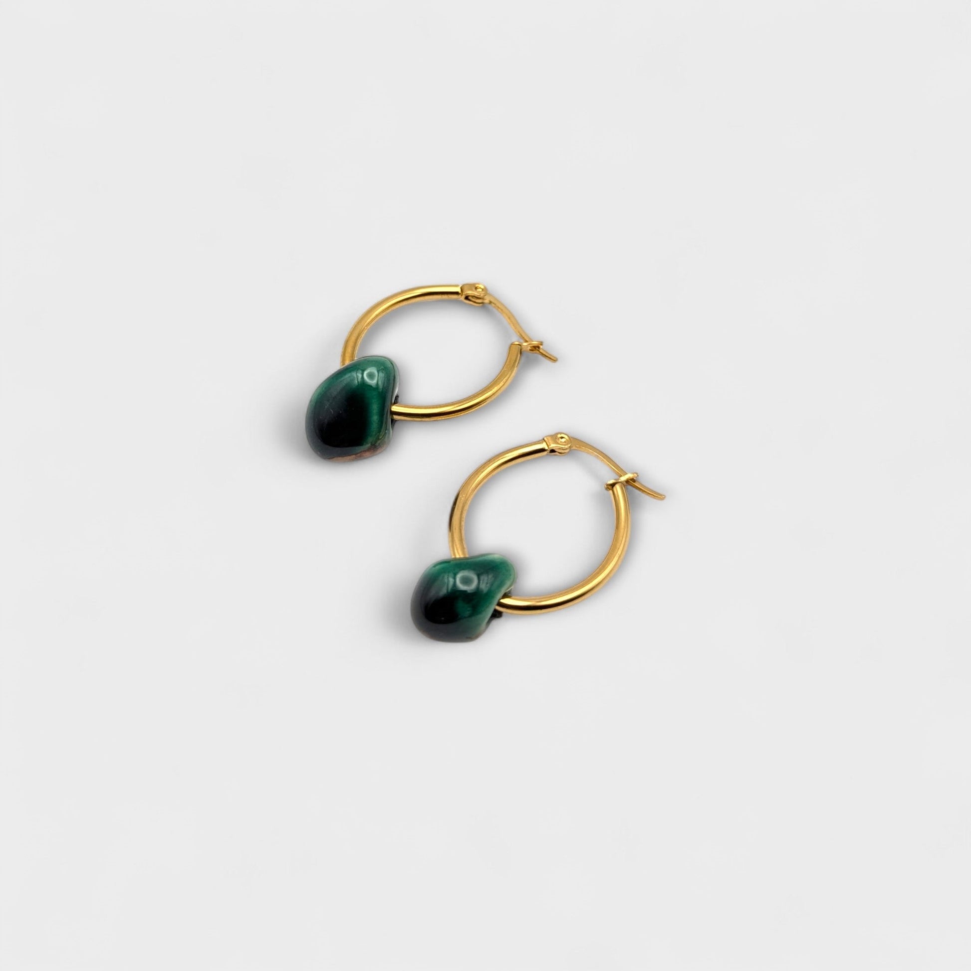 Maximilianas oval hoop earrings with green handcrafted ceramic bead - product shot from top angle