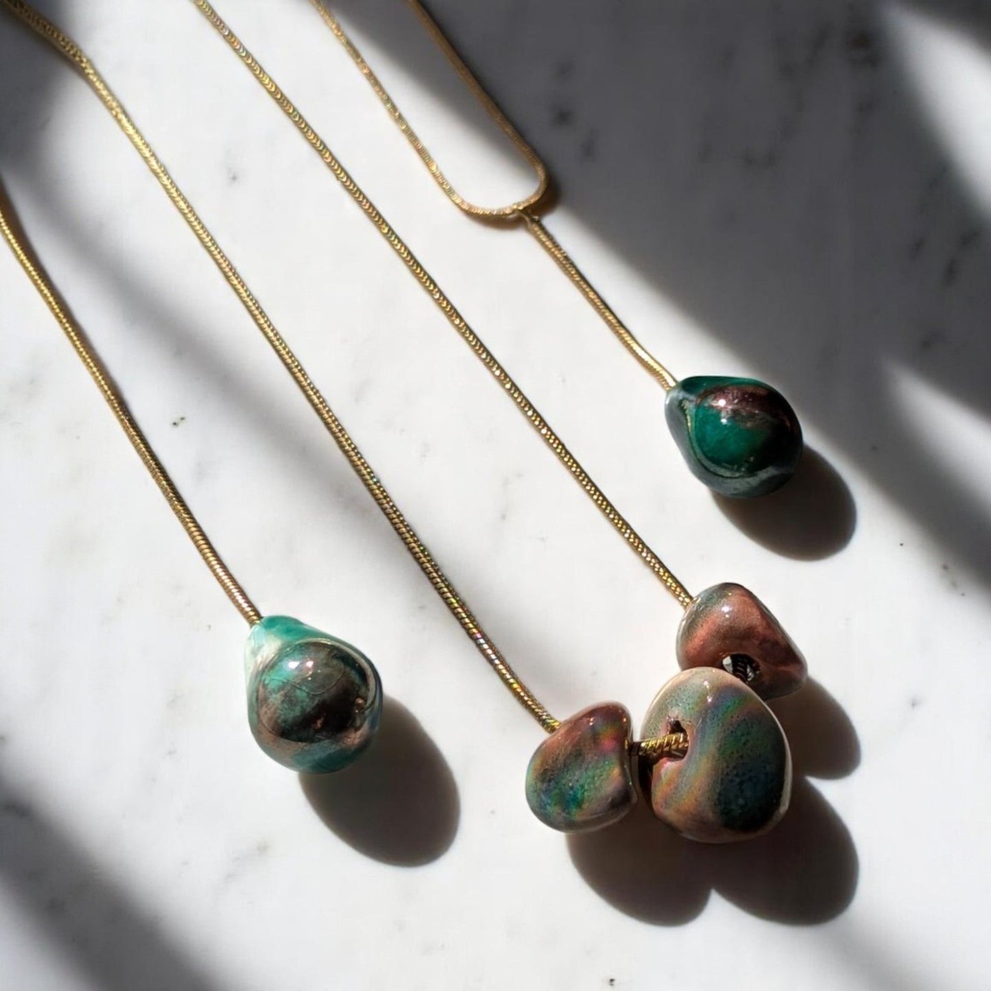 Maximilianas Tres Petras necklace with three forest green ceramic beads - close up shot of ceramic beads