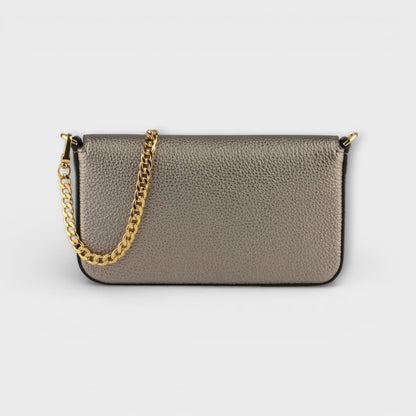 Back view of Pourchet Club gunmetal leather clutch  with a gold chain on a light gray background.